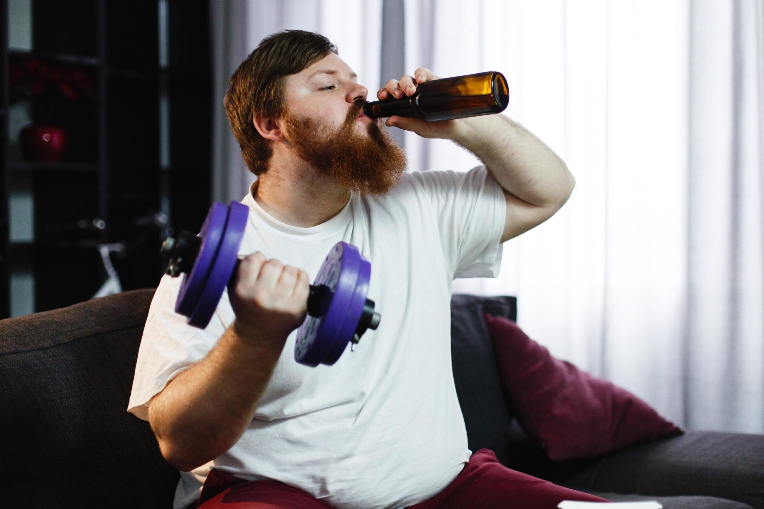 man-drinking-a-beer-while-lifting-weights-free-photo-scaled.jpg